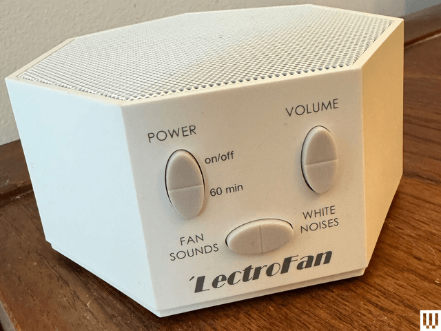 White 7sided device with a speaker on the top and 3 large oval buttons on the front